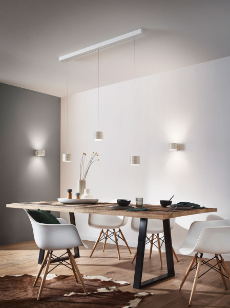 3-fold pendant luminaire Tudor by Oligo with invisible height adjustment and built-in Casambi radio receiver - here as a customer example with luminaire heads in white next to the Tudor wall lights