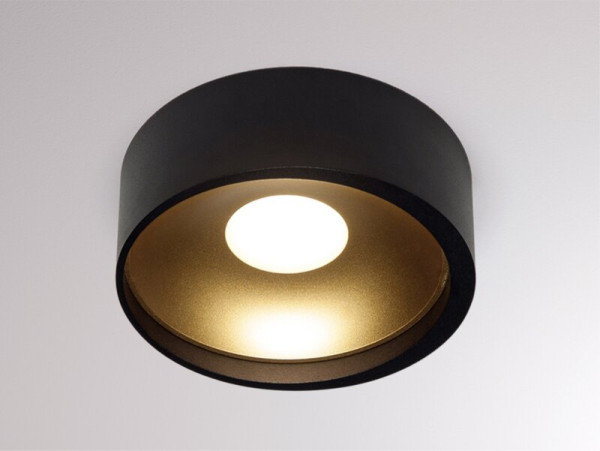Flat ceiling surface mounted spotlight optionally in the surfaces black, black / gold or white